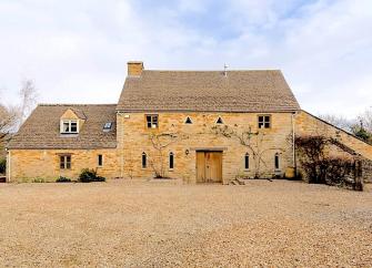 A large Cotswold barn conversion to form a holiday cottage in open countryside.
