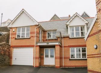 Exterior of a modern, brick-built 2-storey holiday apartment block in Woolacombe.