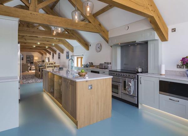 Open plan kitchen with a cooks Island and twin oven and ceramic hob