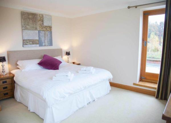 Neutral decorated large bedroom with white linen