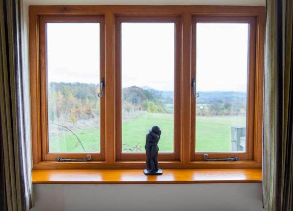 AWindow with figurine ornament and views out to the countryside