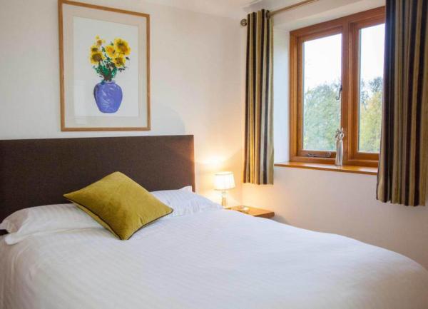 Small neutral bedroom with artwork and cushion
