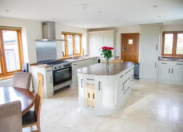 Modern neutral coloured kitchen with an island in 