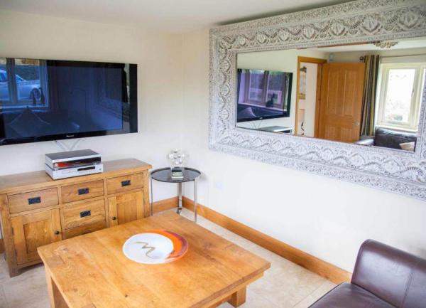 Small lounge with TV and a large mirror