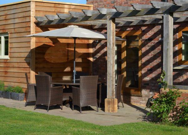 Outdoor dining area with parasol under a gazebo