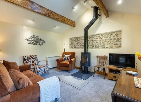 Plover Cottage in Weybourne, Norfolk lounge with woodburner