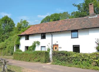 Exterior of a traditional Somerset longhouse in a rural location.