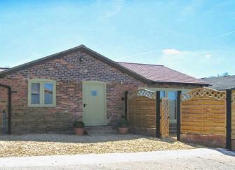 A single-storey bungalow with an off-road parking space for two cars.