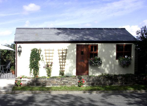 Exterior of a single-storey rural holiday cottage in North Cornwall.