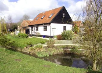 A Norfolk barn conversion overlooks a riverside lawn