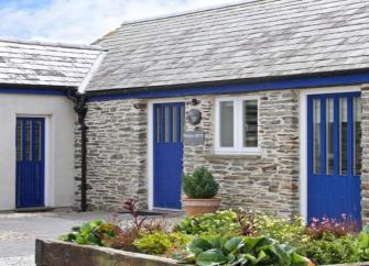 An L-shaped, single-storey barn conversion overlooks a courtyard and a raised flowerbed.