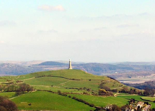 A large stone monument sits on a hill.