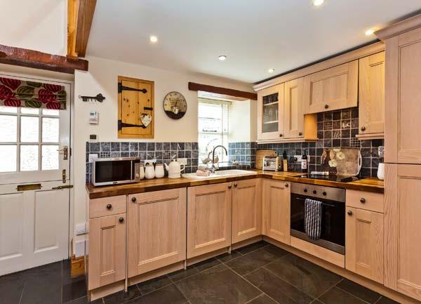 Fitted kitchen with cupboards and appliances.