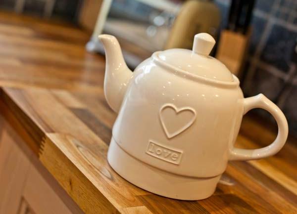 Large ceramic teapot in kitichen.