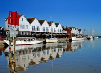 Quayside holiday apartment in Rye overlooks small craft moored to the waterfront at high tide