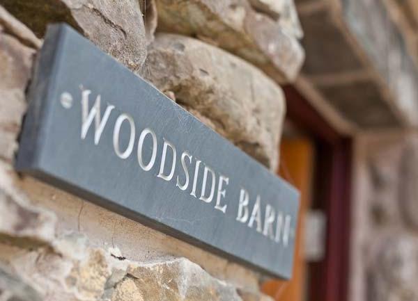 A slate tablet with Woodside Barn engraved on it.
