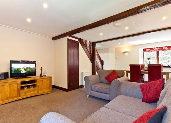 Lounge with sofas, armchair, TV and sideboard