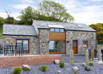 Exterior of a 2-storey, stone barn conversion near Bangor