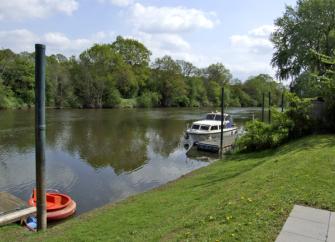 A lawn slope down boat moored on the banks of the River Severn