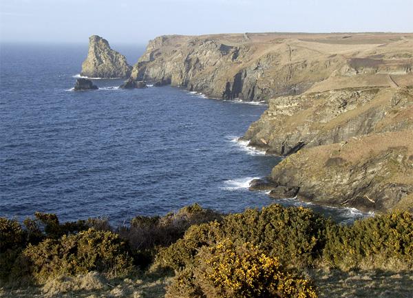 View of the Cornish coast near Tintagel fields, clifftops and a rough sea.