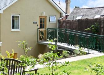 Gable end of a Shropshire Holiday Cottage wth a 1st floor entrance approached via a bridge.