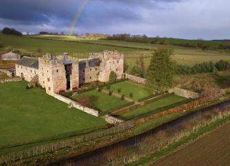 Restored Fortified Country House surrounded by open fields in Cumbria.
