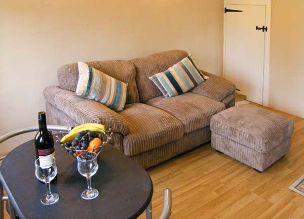 Lounge corner with a sofa, footstool and dining table for twio.