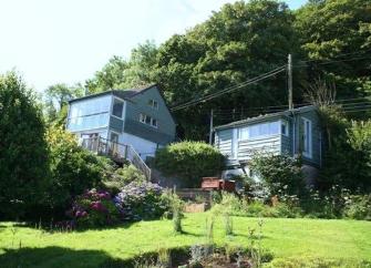 Country Cottage with large garden overlooked by a steep, wooded hill