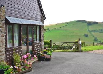 The gable-end of a country cottage surrounded by Exmoor's rolling hills.