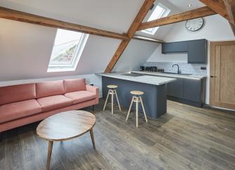 An open-plan lounge-kitchen space in a Whitby holiday apartment.