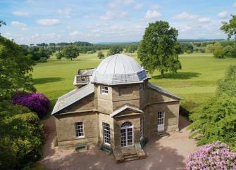 A converted Victorian folly stuled like a temple is surrounded by open parkland.