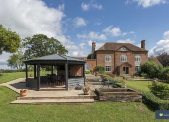 Aa largendouble-fronted, 33-storey detached house overlooks  a spacious garden with an octagonal summerhouse