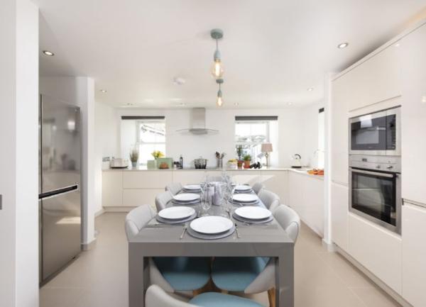 Fitted kitchen with brerakfast table laid for 8.