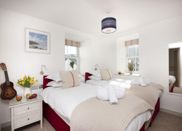 Twin bedroom with beds, bedside cabinets and table lights.