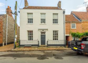 Exterior of a double-fronted, detached, 2-storey Georgian house.