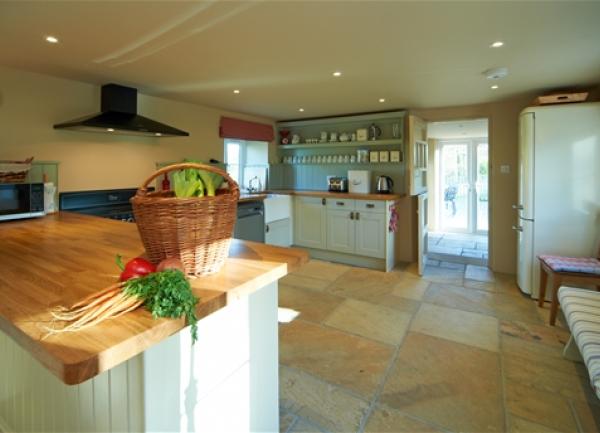 Kitchen with fitted unit and integrated appliances.