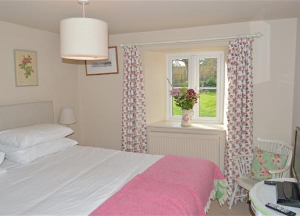 Double bedroom with bed and TV.