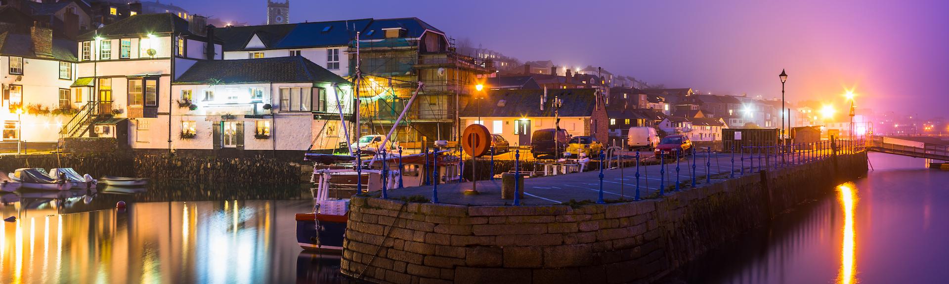 Falmouth Quay illuminations reflect on the water after dark,