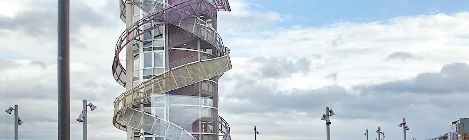A large, modern helter-skelter overlooks a sandy beach in Redcar.