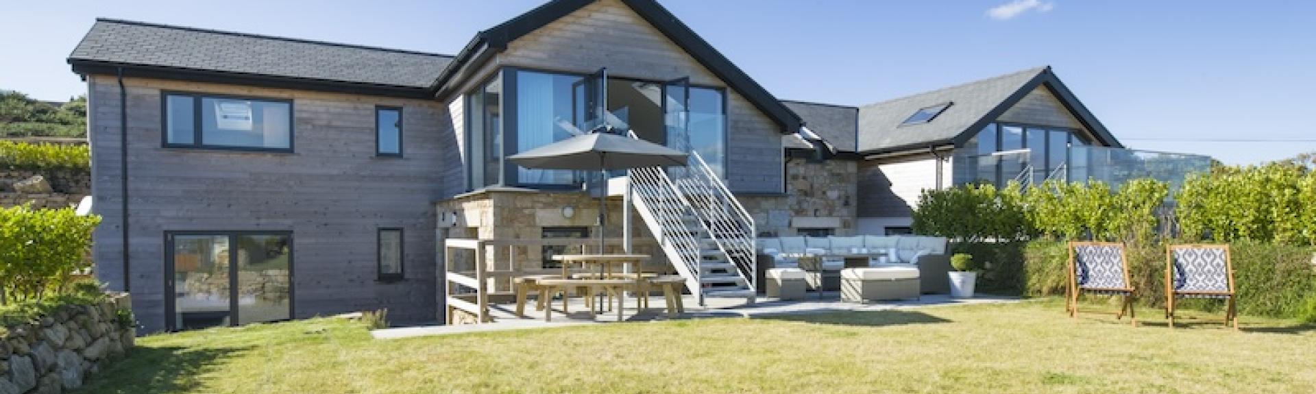 A large wooden eco-lodge over looks an equally large and secure lawn.