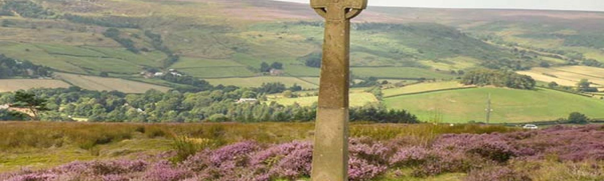 A stone celtic cross at a high point overlooking the north York Moors.