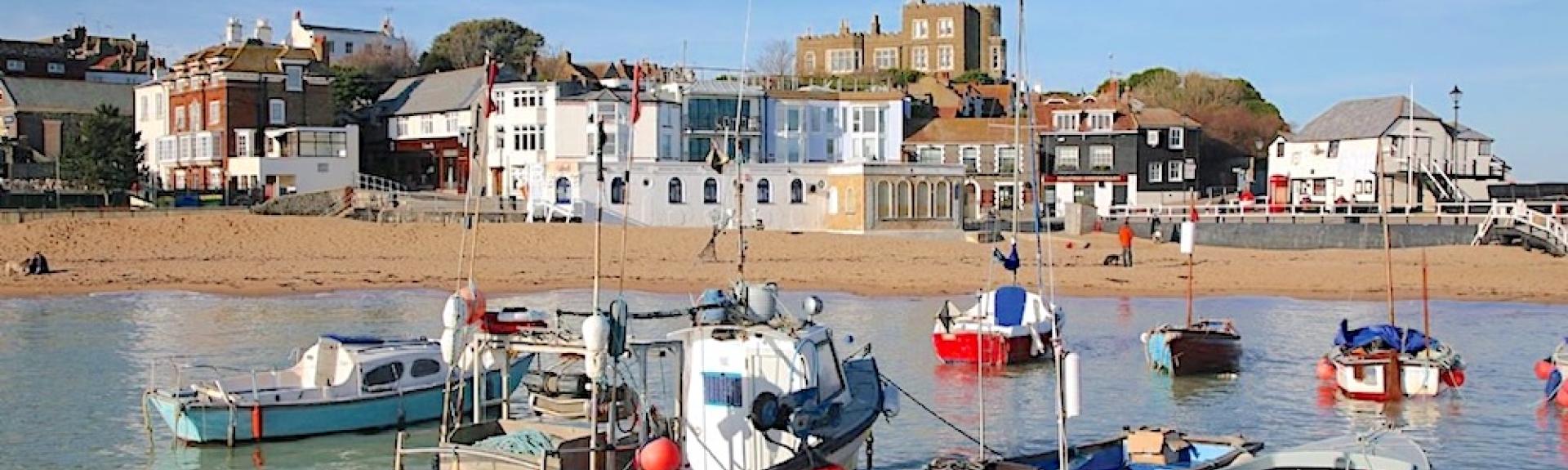 Yachts and small fishing boats anchored in Broadstairs harbour at high tide