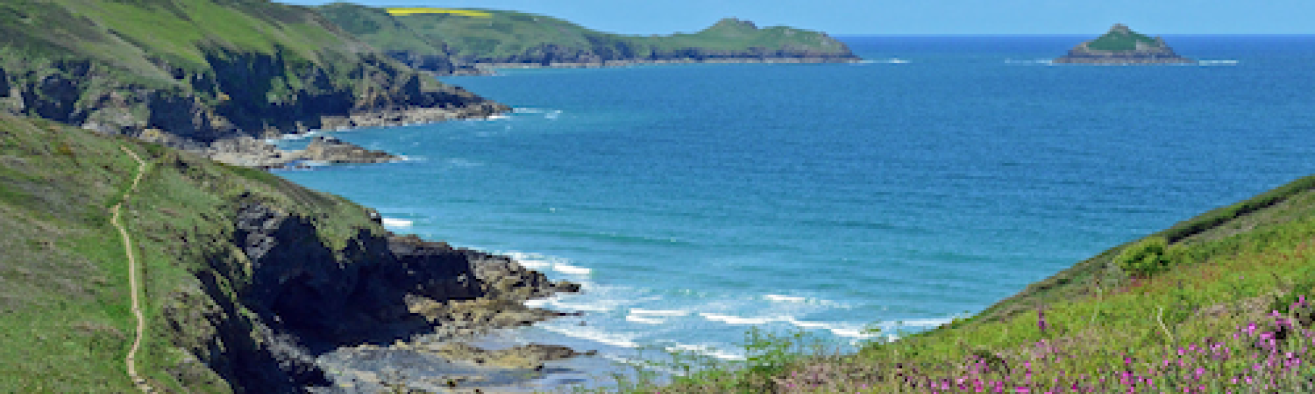 A clifftop view of a bay on the North Cornwall coast.