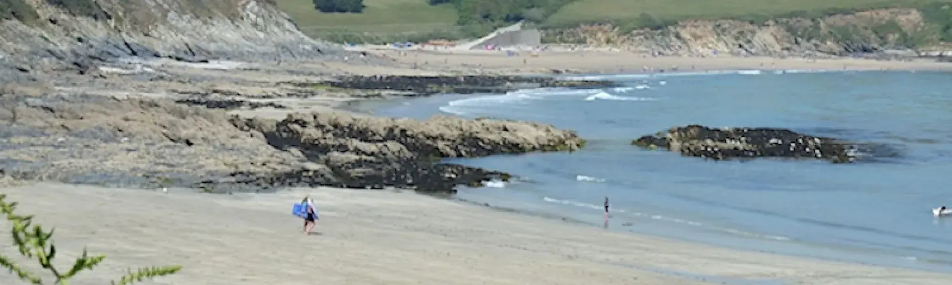 A sandy beach in Cornwall at low tide.