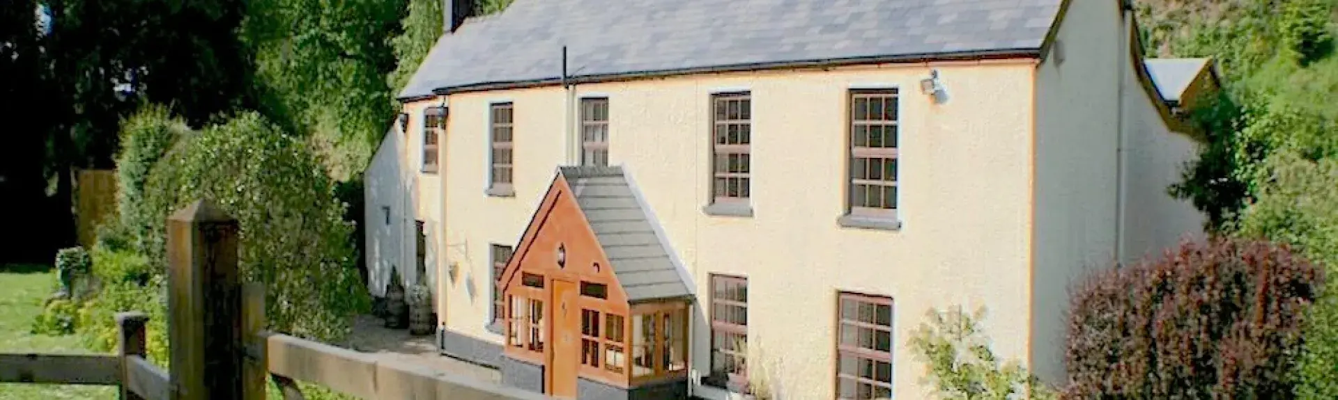 A large cottage overlooks the River Wye in a rural location.
