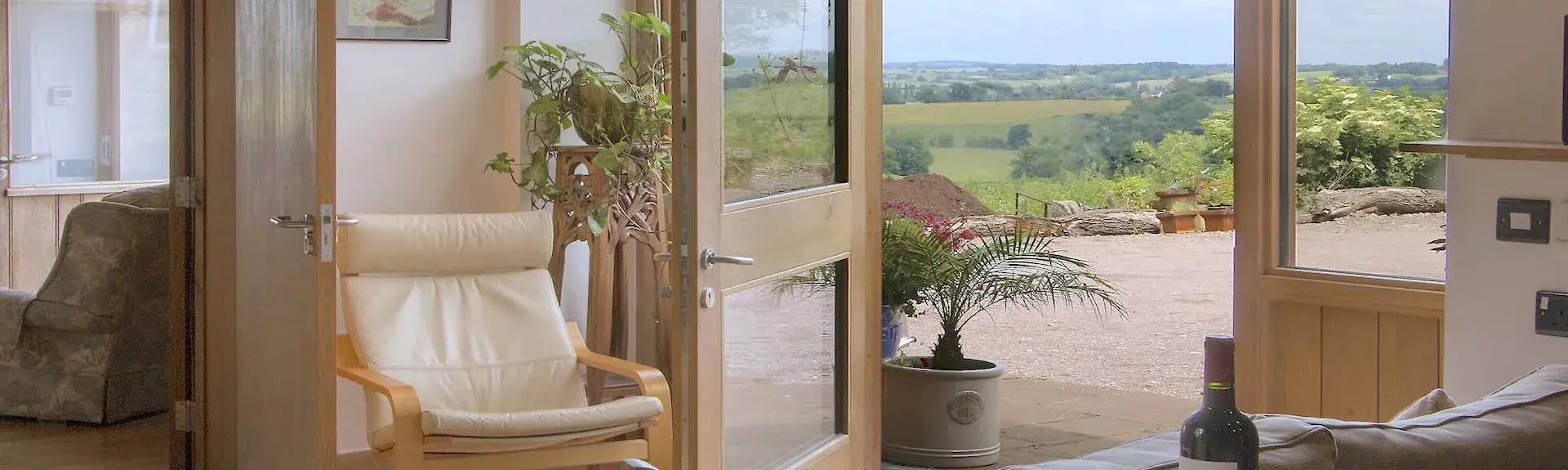 Louunge chairs face open French doors to a deck with far reaching rural views.