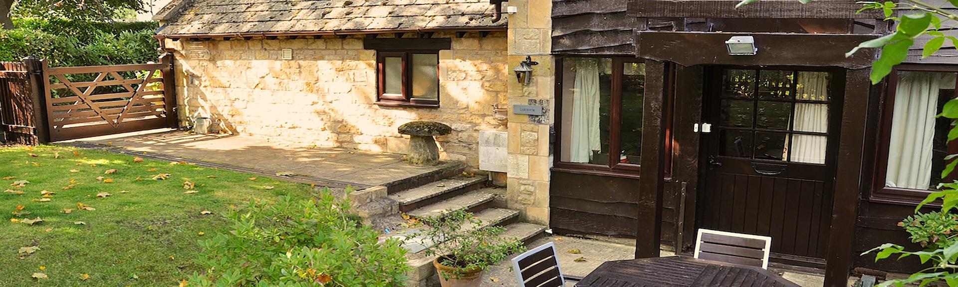 Exterior and garden of a stone-built holiday cottage in The Cotswolds