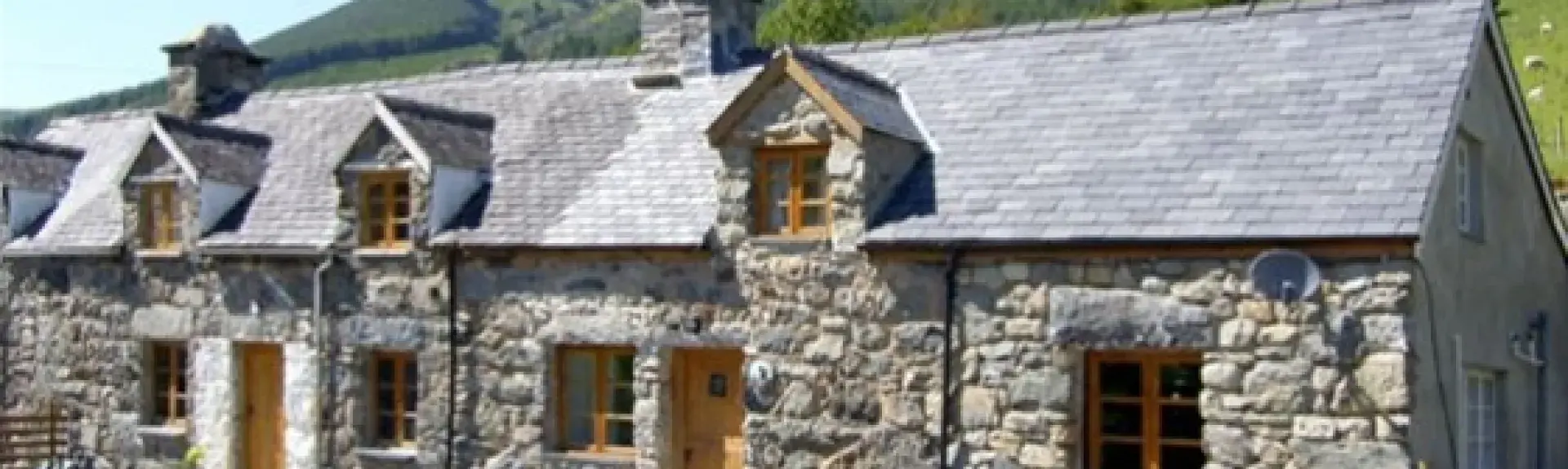 A large stone-built barn conversion in a remote rural setting.