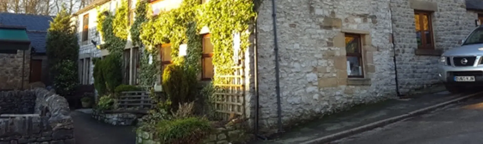 Derby Cottage, a stone-built, ivy-clad Peak District holiday cottage.