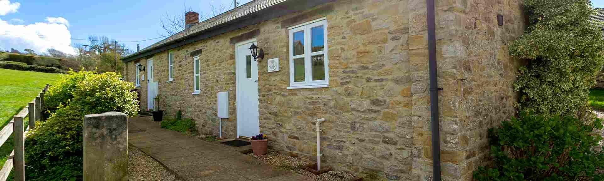Stone-built, single storey barn conversion overlooking open countryside.